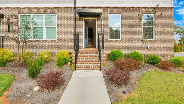 a front view of a house with a garden