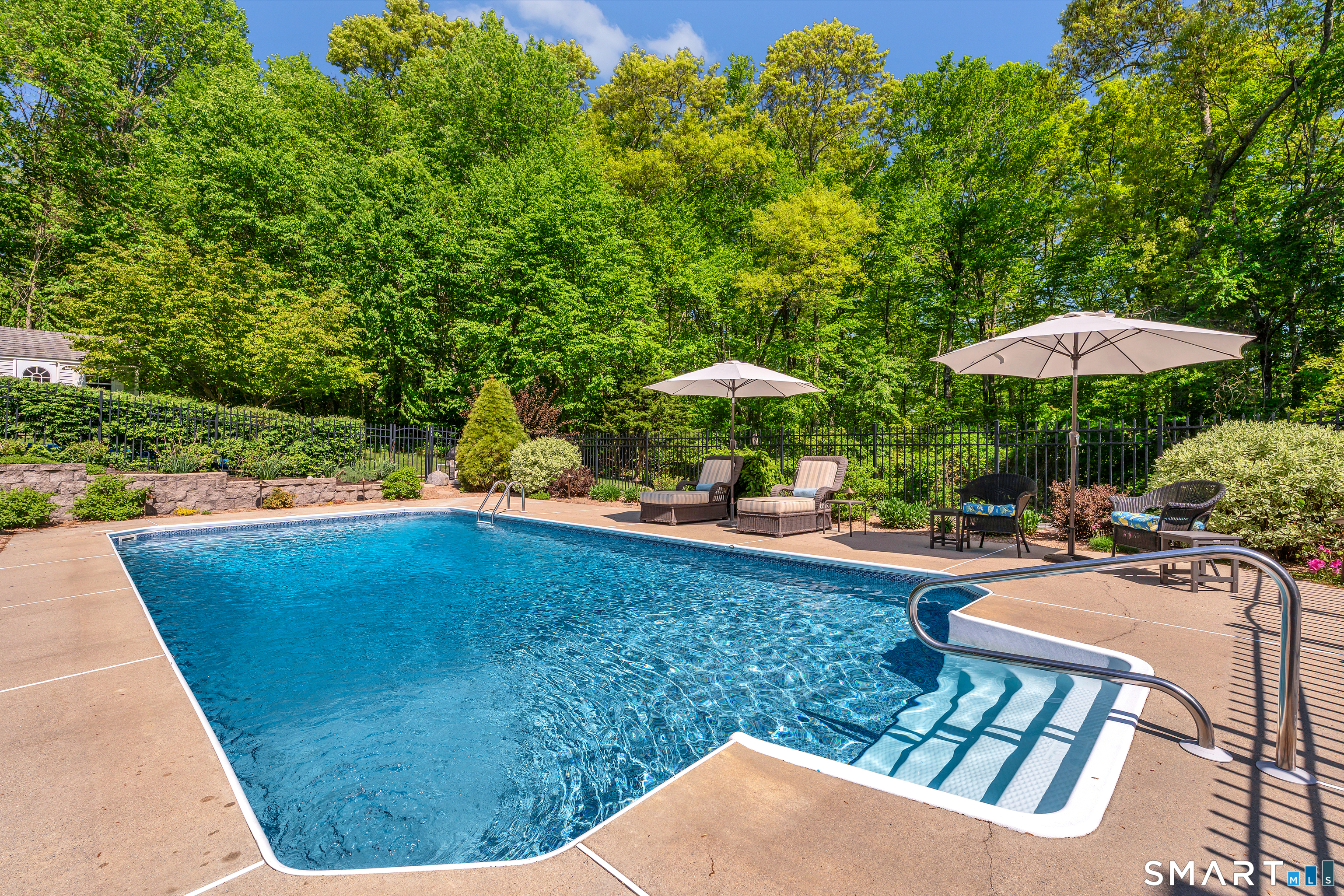 21 Stone Wall Road Salem, CT 06420 - Photo 33 of 38 a view of a swimming pool with lawn chairs under an umbrella