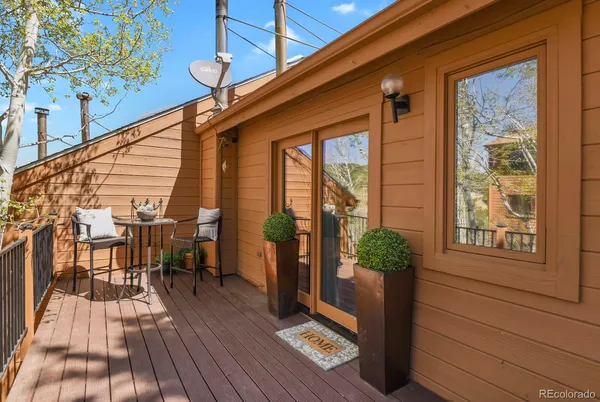a view of a porch with furniture and wooden floor