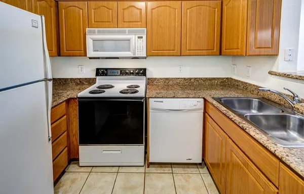 a kitchen with a sink stove and microwave