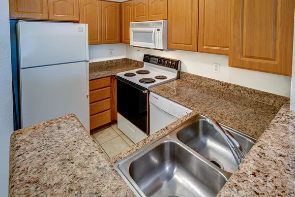 a kitchen with a stove and a refrigerator