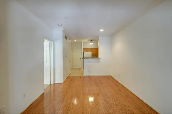 a view of a big room with wooden floor and a bathroom