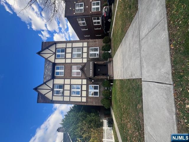 215 Orient Way, Unit B2 Rutherford, NJ 07070 - Photo 1 of 29 a front view of a residential apartment building with a yard