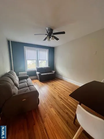 a living room with furniture and a lamp