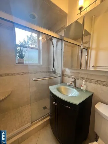 a bathroom with a sink vanity granite and a mirror