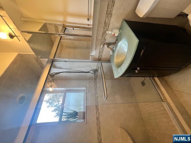 215 Orient Way, Unit B2 Rutherford, NJ 07070 - Photo 20 of 29 a bathroom with a sink vanity granite and a mirror