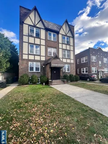 a front view of a building with a garden