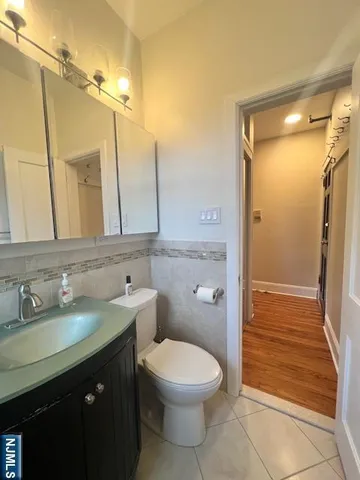 a bathroom with a double vanity sink toilet and shower