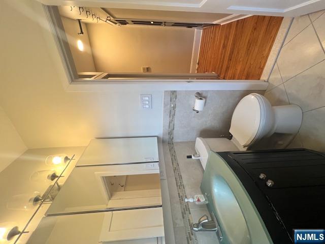 215 Orient Way, Unit B2 Rutherford, NJ 07070 - Photo 21 of 29 a bathroom with a double vanity sink toilet and shower