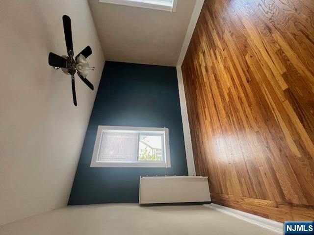 215 Orient Way, Unit B2 Rutherford, NJ 07070 - Photo 23 of 29 a view of an empty room with wooden floor and a window