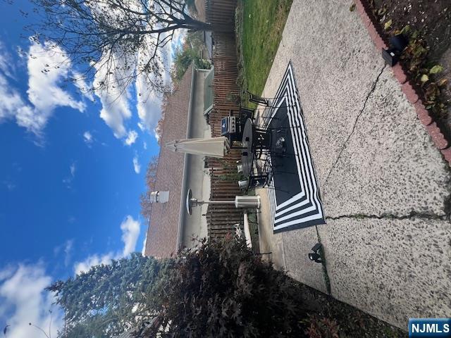 215 Orient Way, Unit B2 Rutherford, NJ 07070 - Photo 25 of 29 a view of a patio with couches and table and chairs with wooden fence