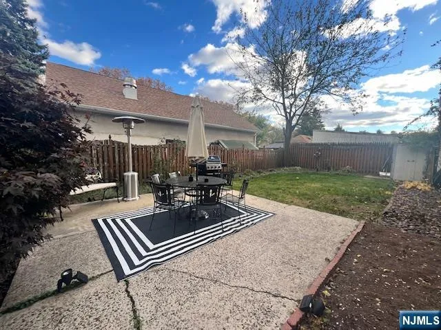 a view of a backyard with sitting area