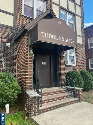 a front view of a brick building with a yard