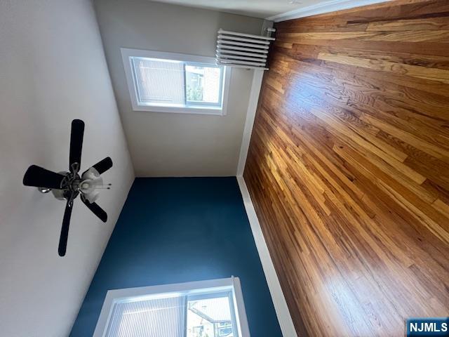 215 Orient Way, Unit B2 Rutherford, NJ 07070 - Photo 6 of 29 a view of an empty room with wooden floor and a window