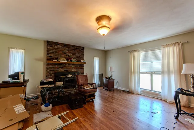 a view of a workspace with furniture and a window