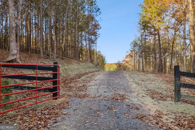 a backyard of a house with trees and outdoor seating