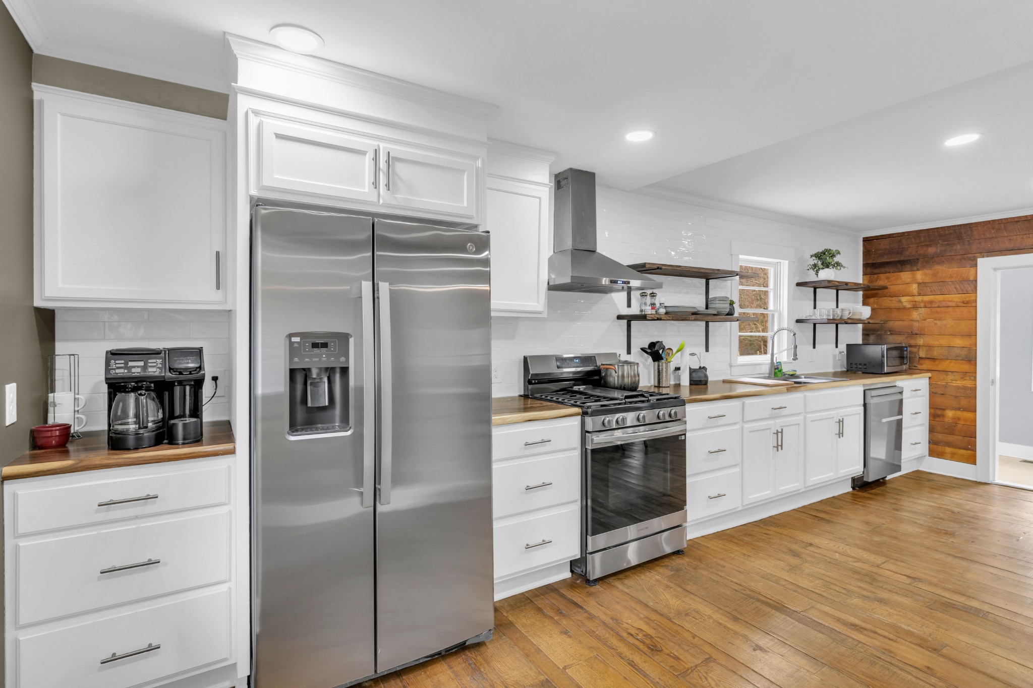 3039 Pigg Hollow Road Petersburg, TN 37144 - Photo 21 of 38 a kitchen with stainless steel appliances white cabinets and wooden floor