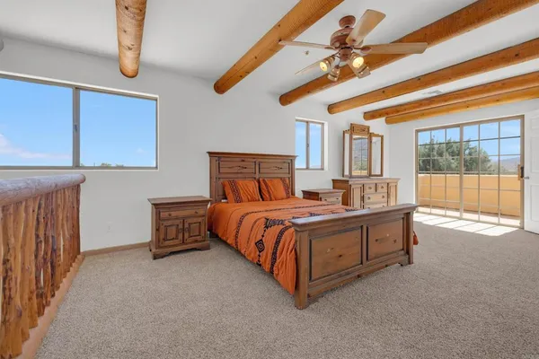 a view of a house with a large window and wooden fence