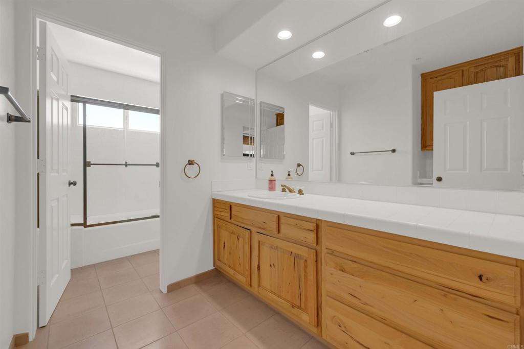 6226 Split Mountain Road Borrego Springs, CA 92004 - Photo 22 of 57 a spacious bathroom with a double vanity sink a mirror and a bathtub