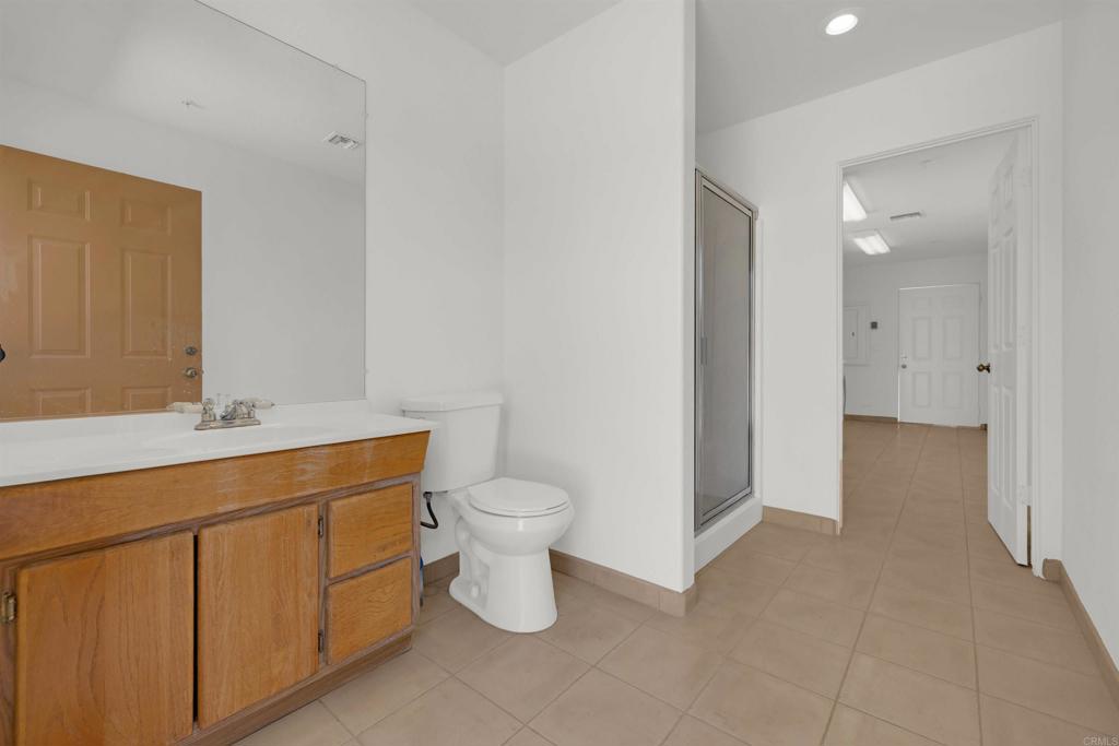 6226 Split Mountain Road Borrego Springs, CA 92004 - Photo 31 of 57 a spacious bathroom with a toilet sink and mirror