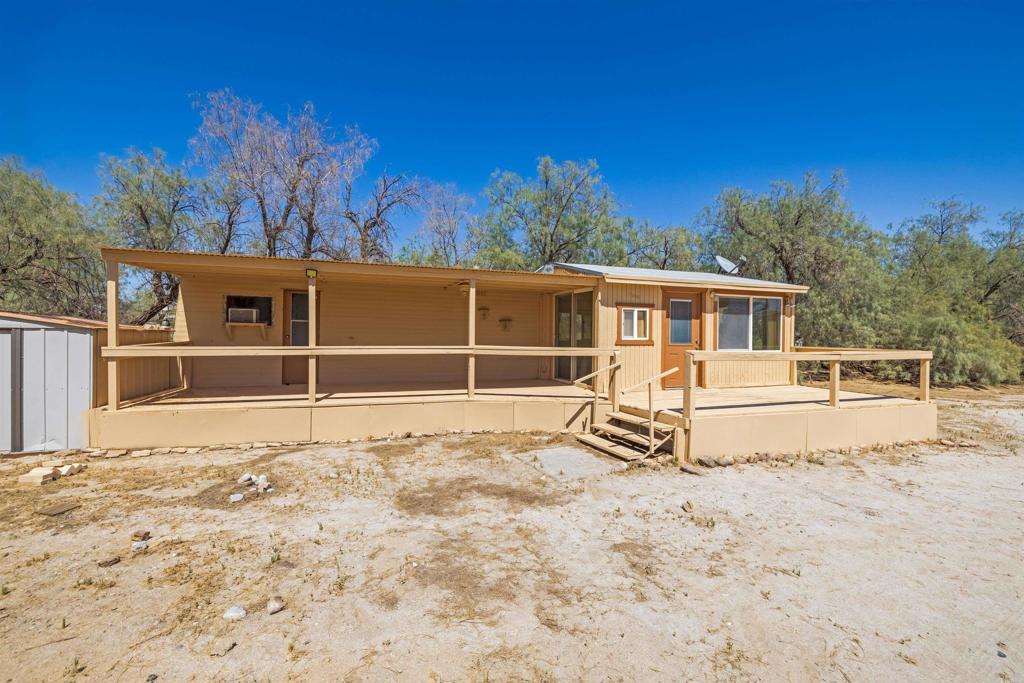 6226 Split Mountain Road Borrego Springs, CA 92004 - Photo 44 of 57 a view of a house with a large window and wooden fence