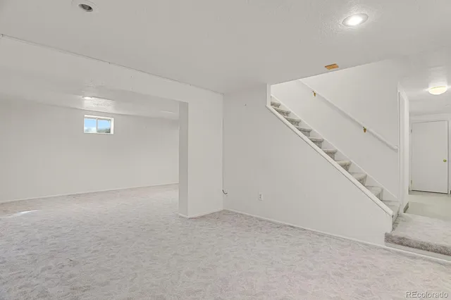 a view of an empty room with stairs