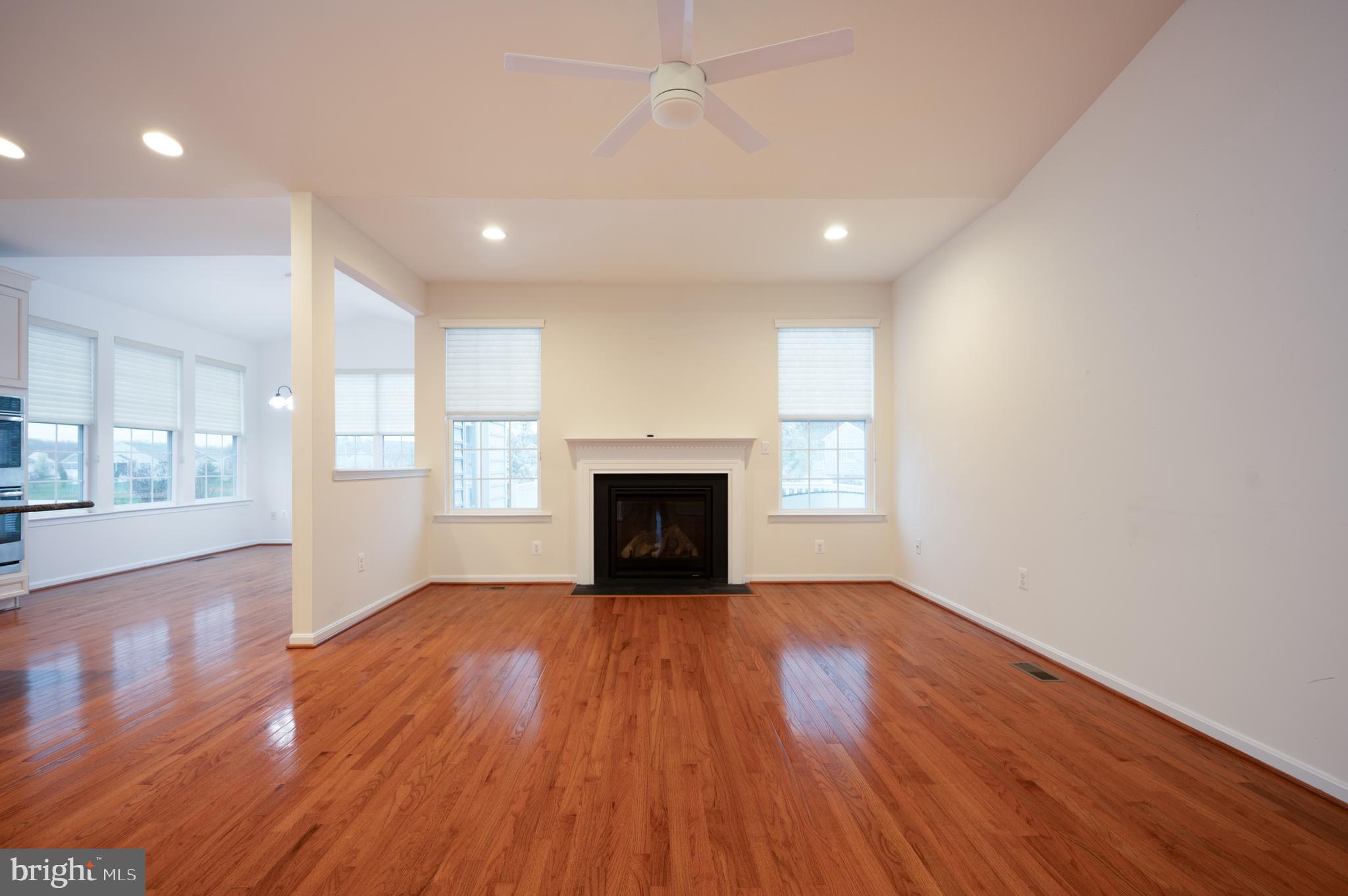 173 Silver Maple Road Middletown, DE 19709 - Photo 11 of 36 a view of an empty room with wooden floor and a window
