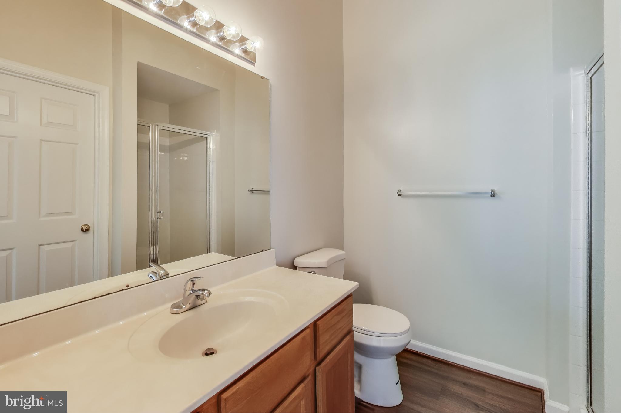 13504 Hayworth Drive Rockville, MD 20854 - Photo 15 of 31 a bathroom with a toilet a sink and mirror