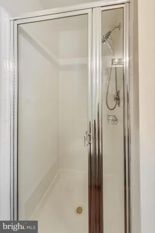 a bathroom with a glass shower door