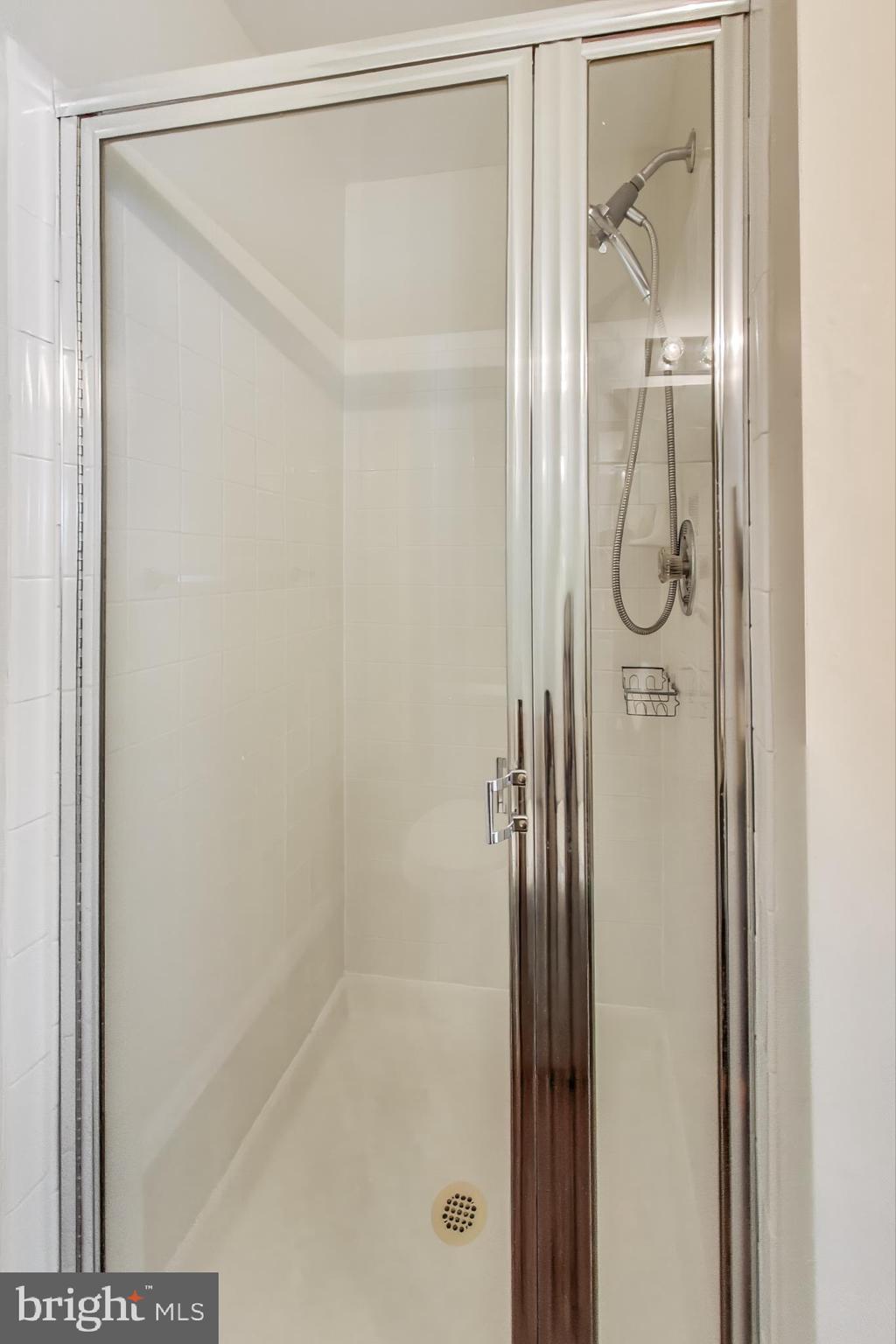 13504 Hayworth Drive Rockville, MD 20854 - Photo 16 of 31 a bathroom with a glass shower door