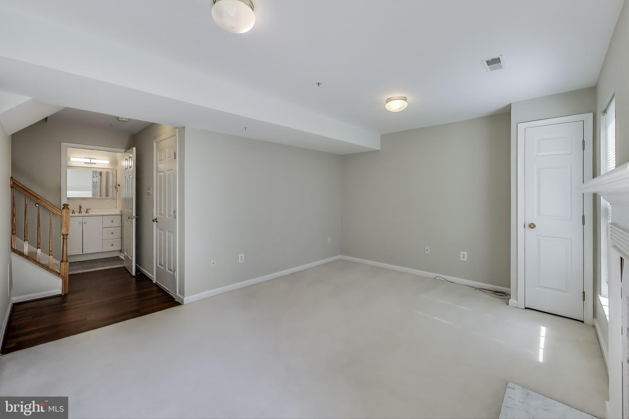 13504 Hayworth Drive Rockville, MD 20854 - Photo 25 of 31 an empty room with wooden floor and windows