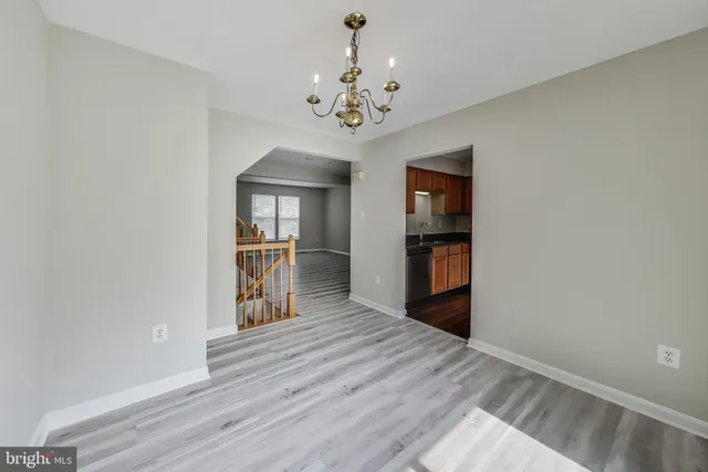 a view of an empty room with a kitchen
