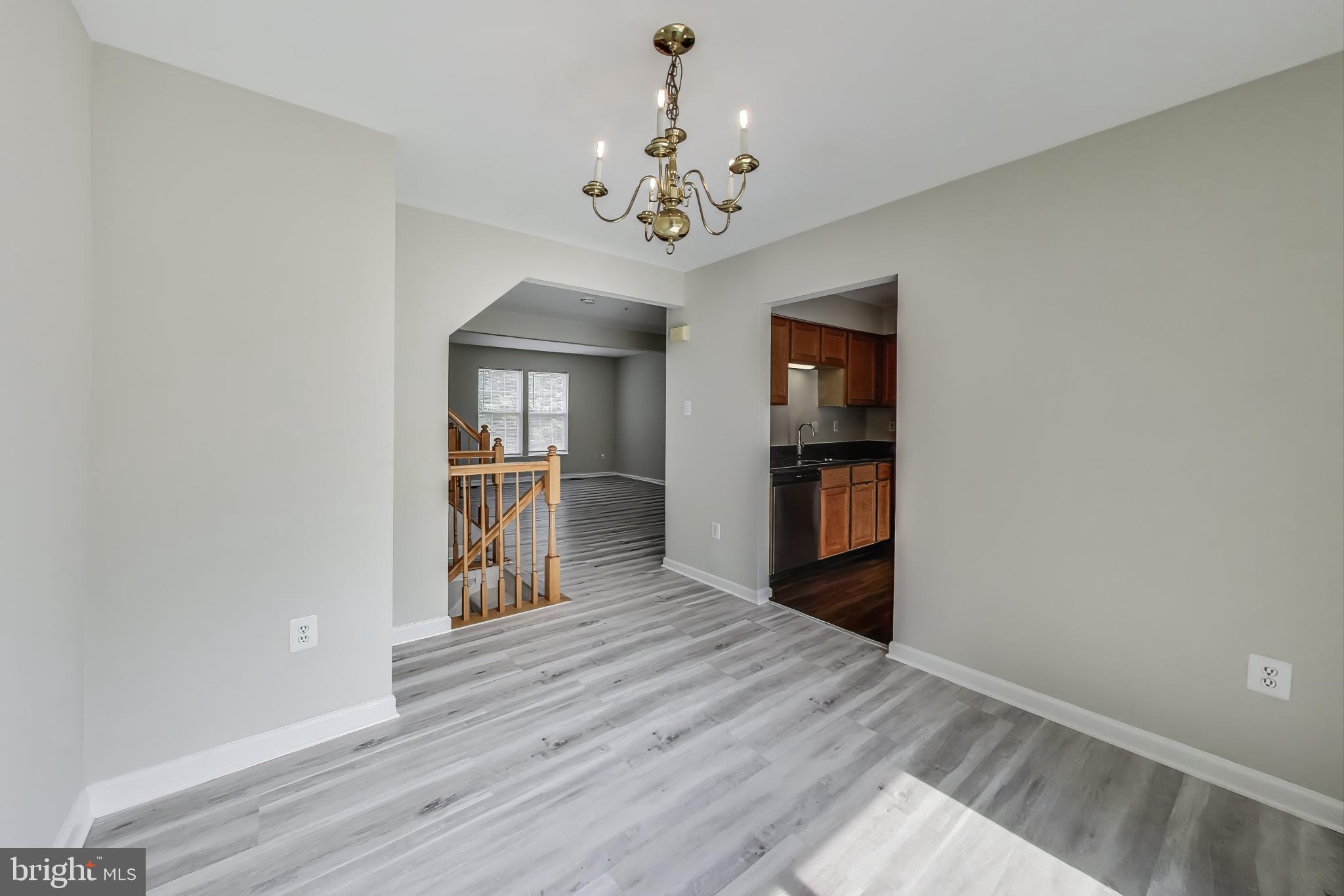 13504 Hayworth Drive Rockville, MD 20854 - Photo 3 of 31 a view of an empty room with a kitchen