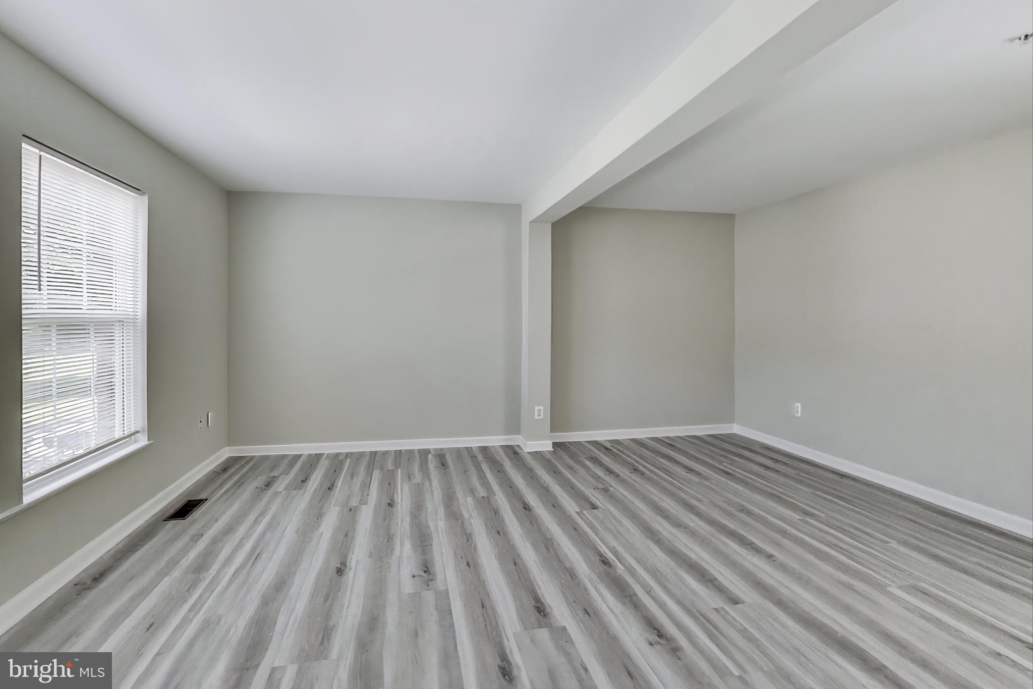 13504 Hayworth Drive Rockville, MD 20854 - Photo 4 of 31 wooden floor in an empty room with a window