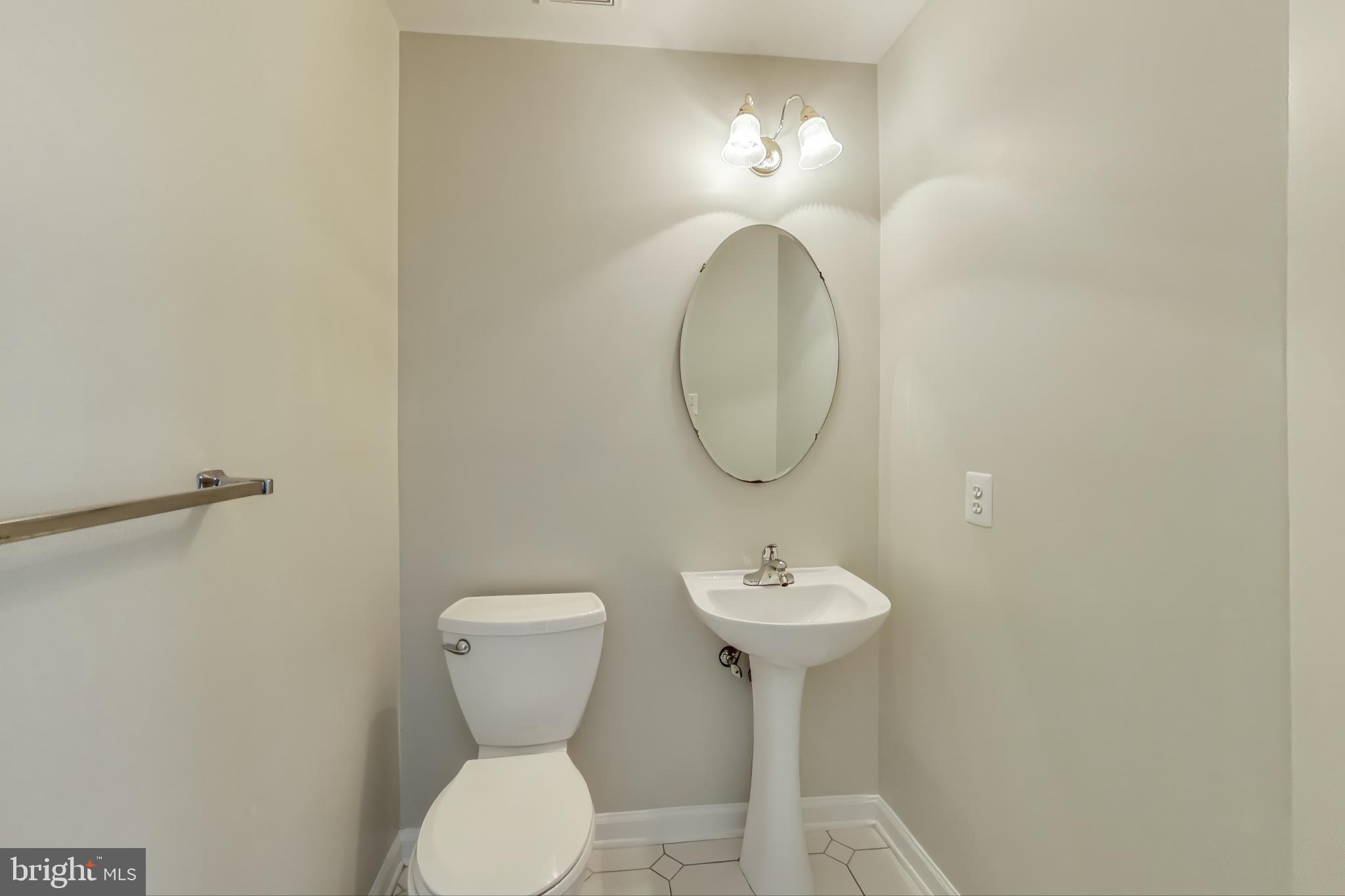 13504 Hayworth Drive Rockville, MD 20854 - Photo 10 of 31 a bathroom with a toilet sink and mirror