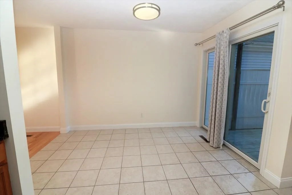 132 Howe Street, Unit B Natick, MA 01760 - Photo 17 of 32 an empty room with windows