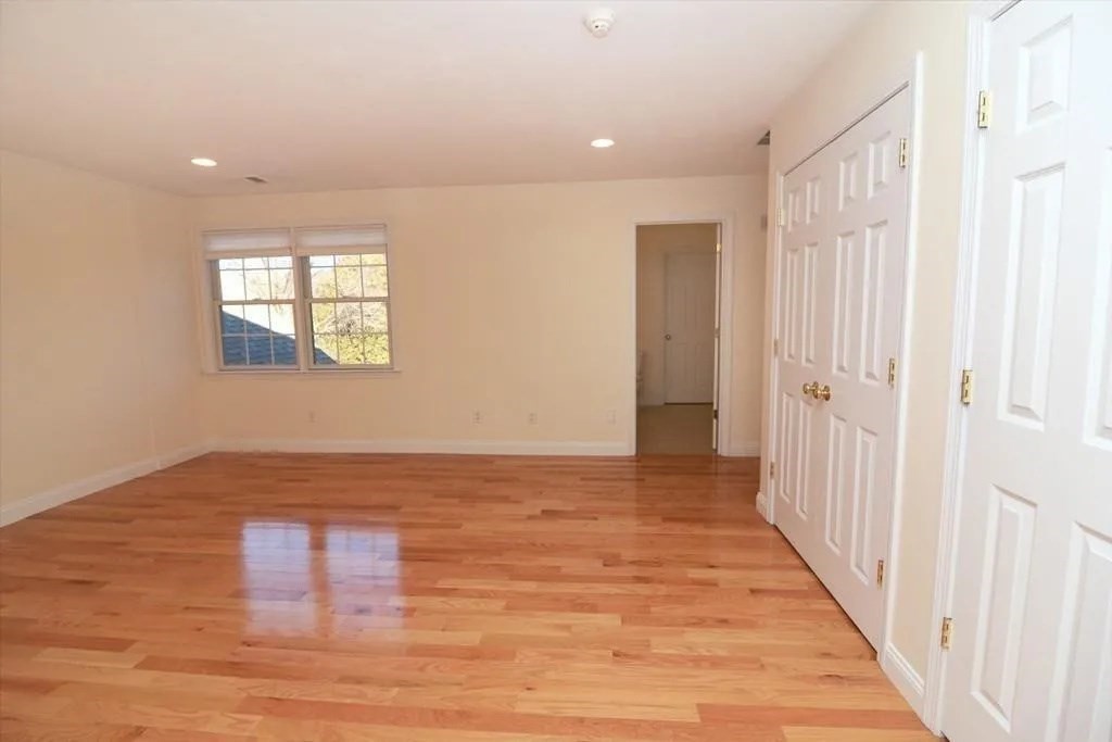 132 Howe Street, Unit B Natick, MA 01760 - Photo 25 of 32 a view of hallway with wooden floor