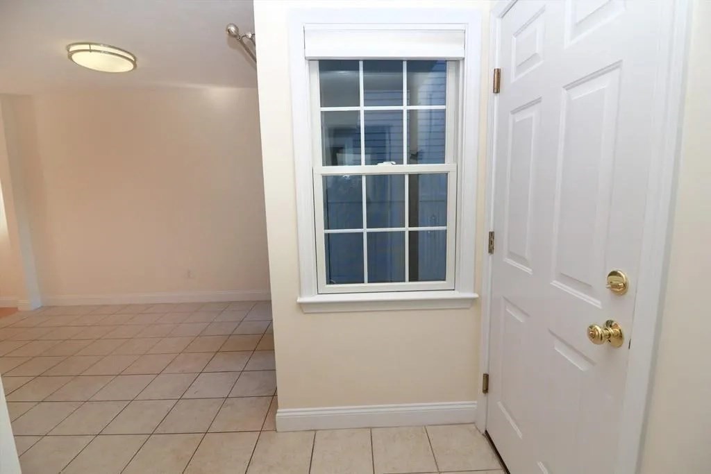 132 Howe Street, Unit B Natick, MA 01760 - Photo 5 of 32 a view of empty room with windows