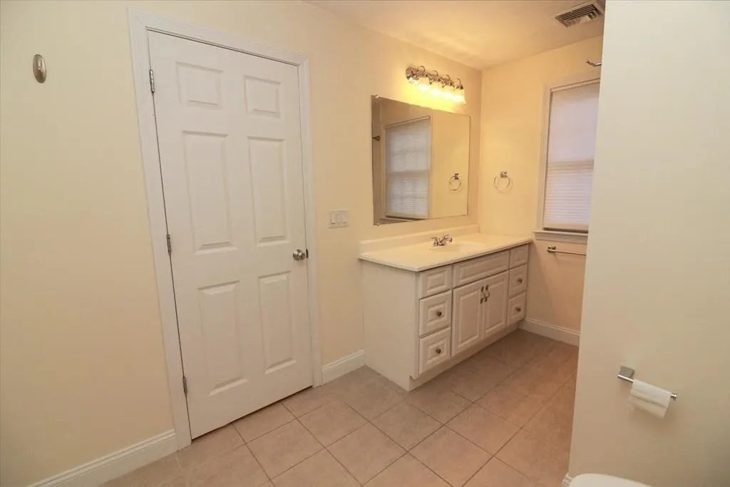 132 Howe Street, Unit B Natick, MA 01760 - Photo 10 of 32 a bathroom with a sink and a mirror