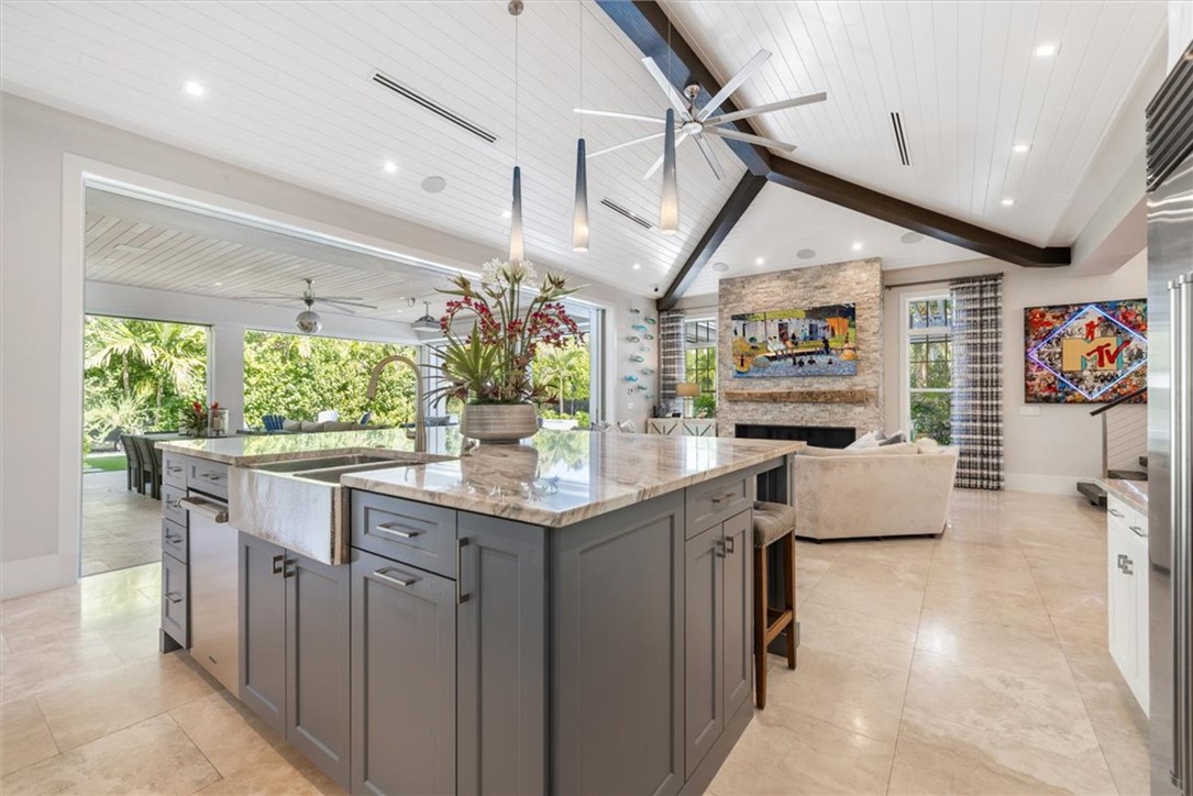 936 Surfsedge Way Vero Beach, FL 32963 - Photo 21 of 36 a kitchen with stainless steel appliances granite countertop a stove and cabinets