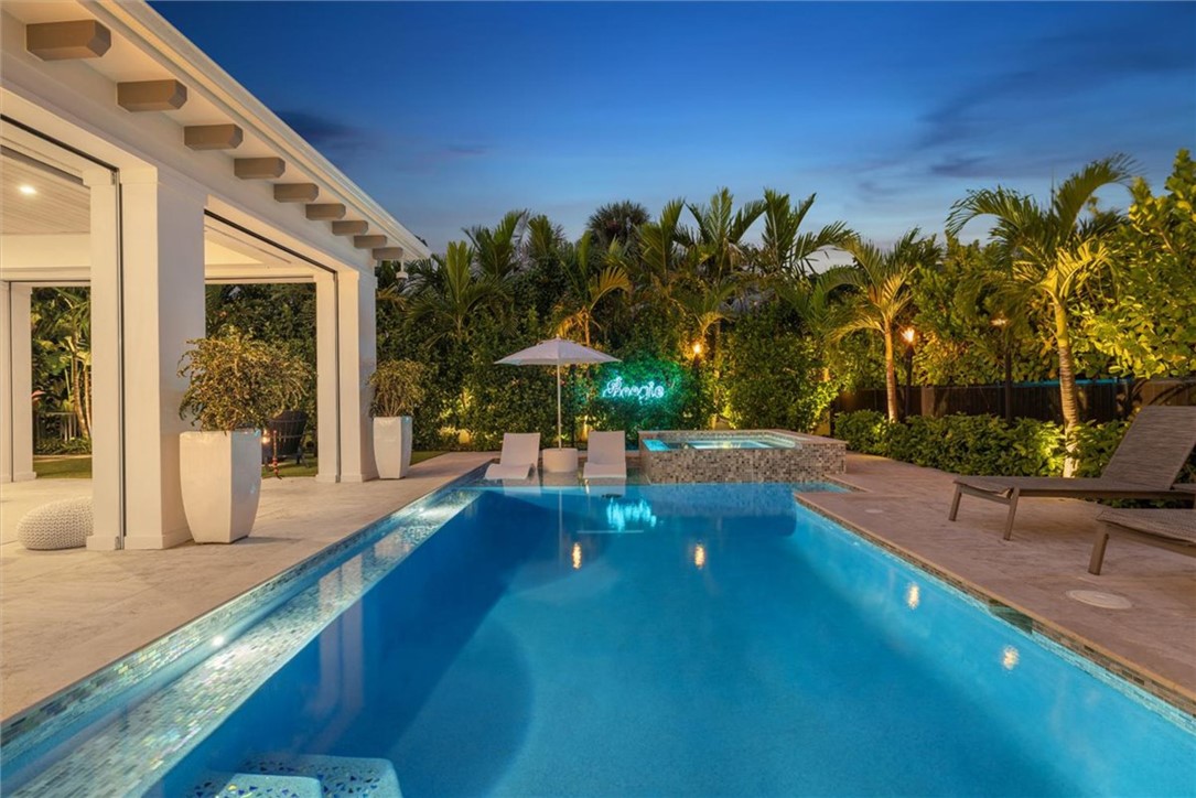 936 Surfsedge Way Vero Beach, FL 32963 - Photo 4 of 36 a view of a swimming pool with a patio