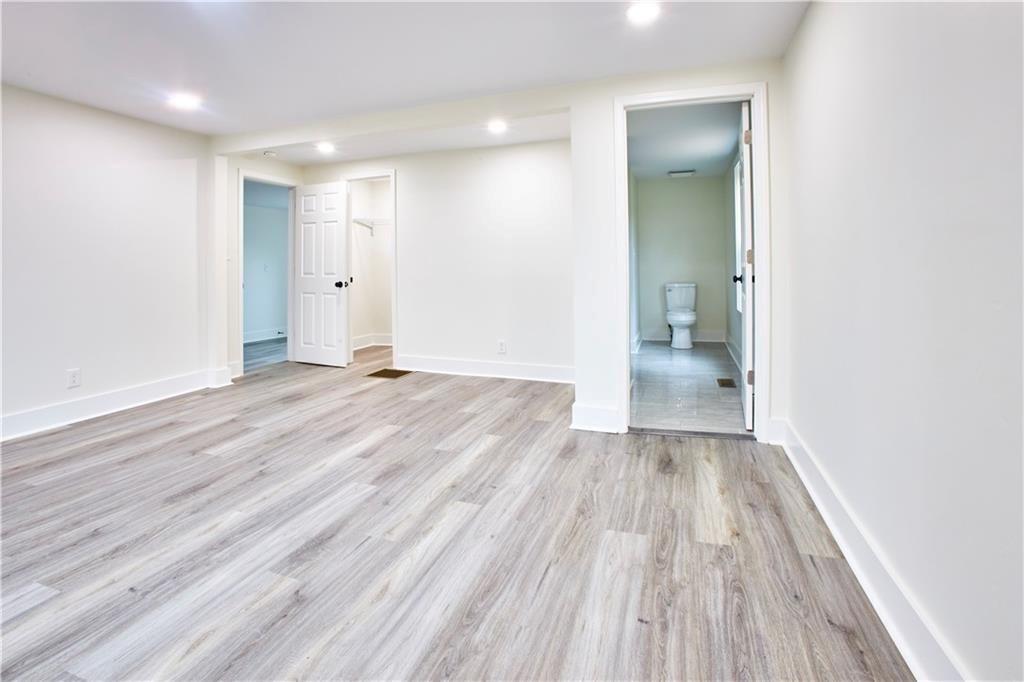 184 Scott Street Northwest Atlanta, GA 30314 - Photo 14 of 29 an empty room with wooden floor and a toilet