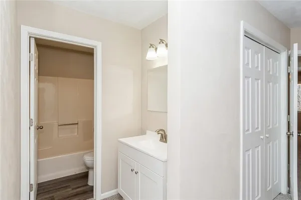 a bathroom with a toilet sink and mirror