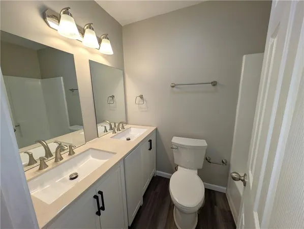 a bathroom with a sink a toilet and a window
