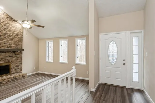 a view of a kitchen with a sink wooden cabinets and a window