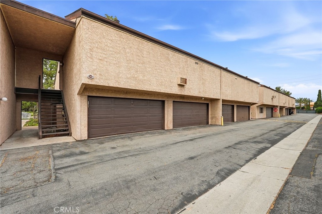 7890 East Spring Street, Unit 11E Long Beach, CA 90815 - Photo 38 of 40 a front view of a house with garage