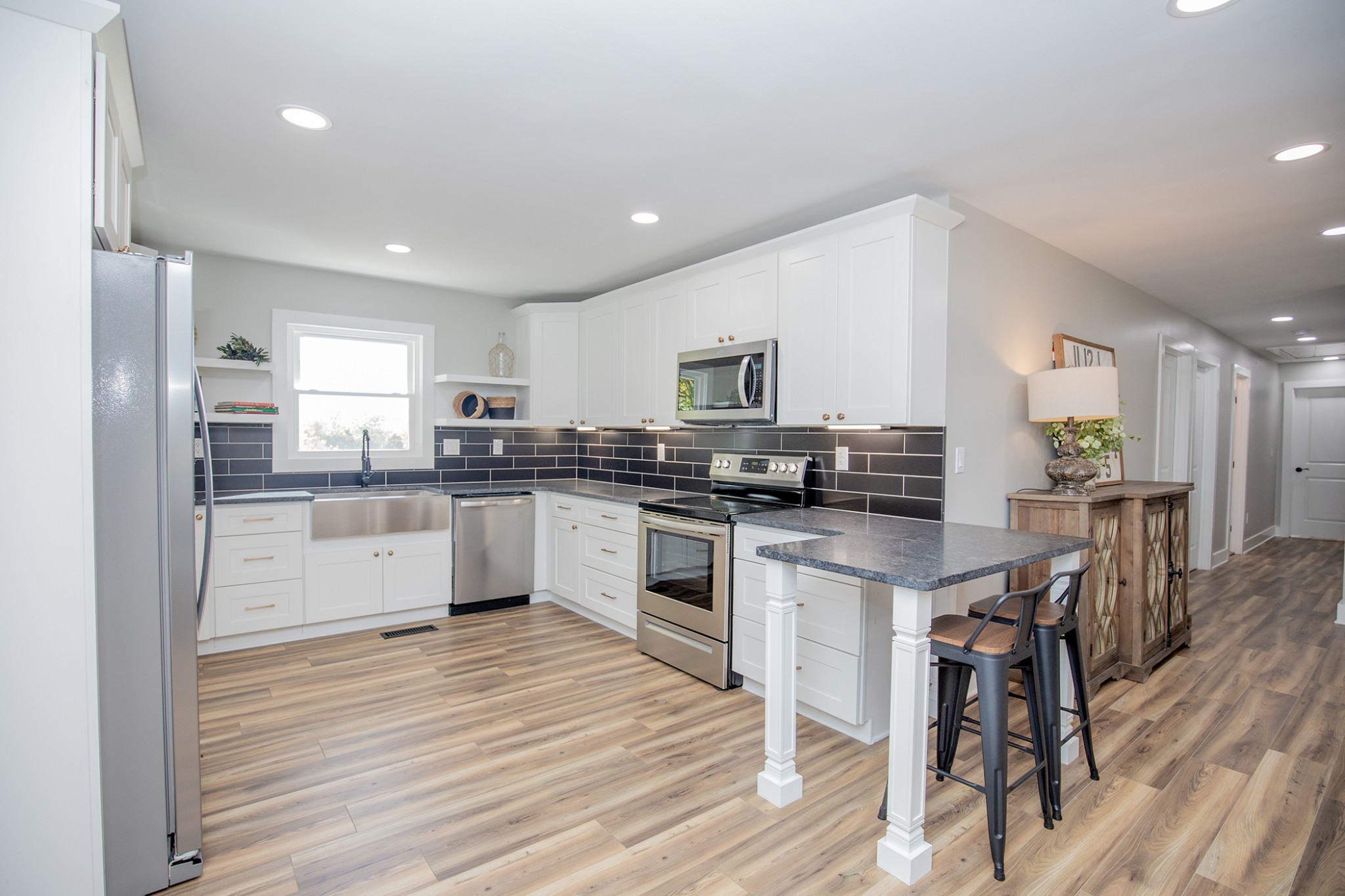 113 Old Parkers Chapel Road Portland, TN 37148 - Photo 3 of 27 a kitchen with white cabinets stainless steel appliances and center island