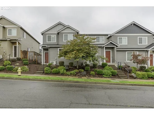 a front view of a house with a garden