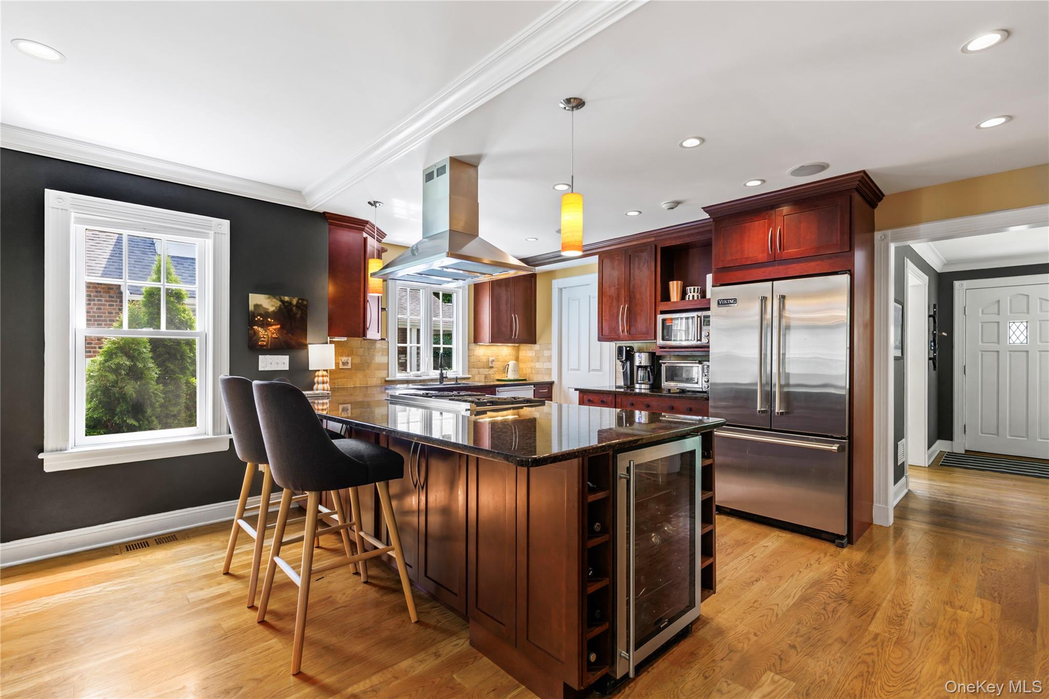 12 Kenmare Road Larchmont, NY 10538 - Photo 9 of 36 The generous at-the-counter dining and the wine refrigerator create a perfect transitional space for casual meals and entertaining.