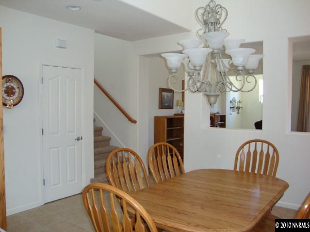 13765 Seabiscuit Drive Reno, NV 89521 - Photo 2 of 9 a view of a dining room and hall with furniture